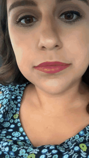 gif of author putting a lipstick