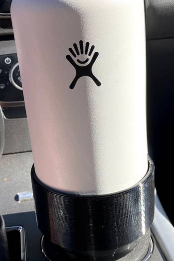 a hydroflask water bottle in the cupholder adaptor 
