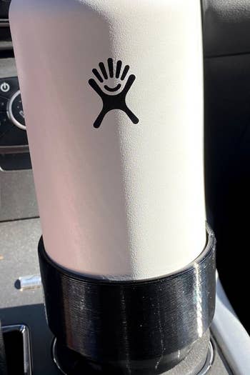 a hydroflask water bottle in the cupholder adaptor 