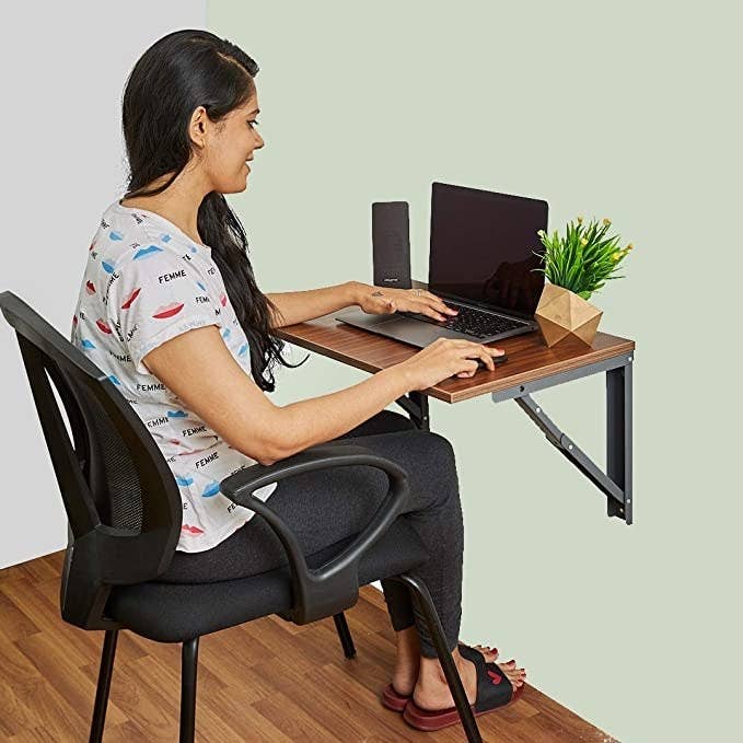 Woman sitting at the fold-away desk