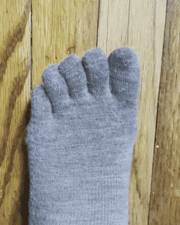 gif of the writer spreading her toes apart in the grey crew socks