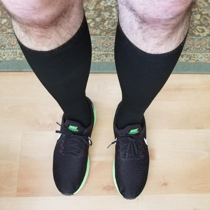 reviewer wearing the black socks with running shoes