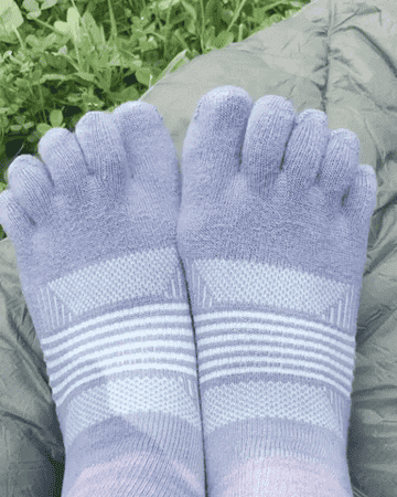 gif of the writer wiggling her toes in grey, blue, and purple toe socks