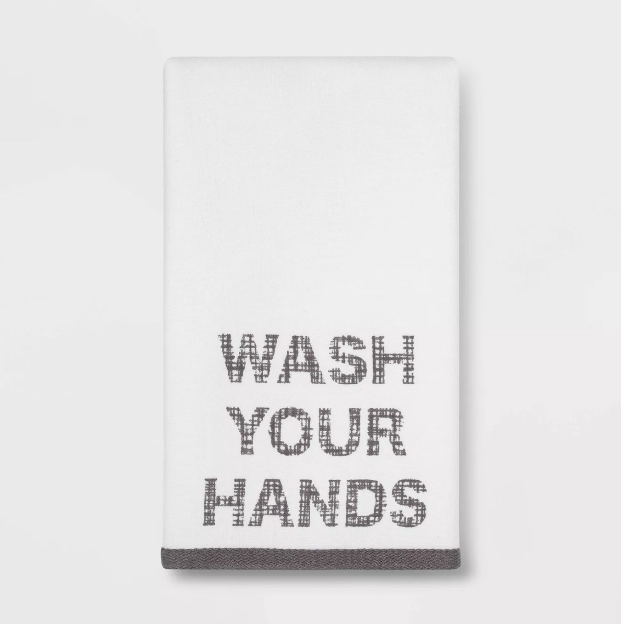 The white hand towel says &quot;WASH YOUR HANDS&quot; in a fabric patterns large block font in a charcoal gray with a matching solid trim at the bottom