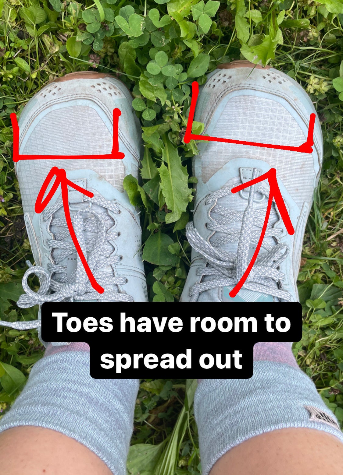 writer in the tow socks and altra trail runners captioned toes have room to spread out with arrows illustrating where her toes are in the shoe&#x27;s wide toe box