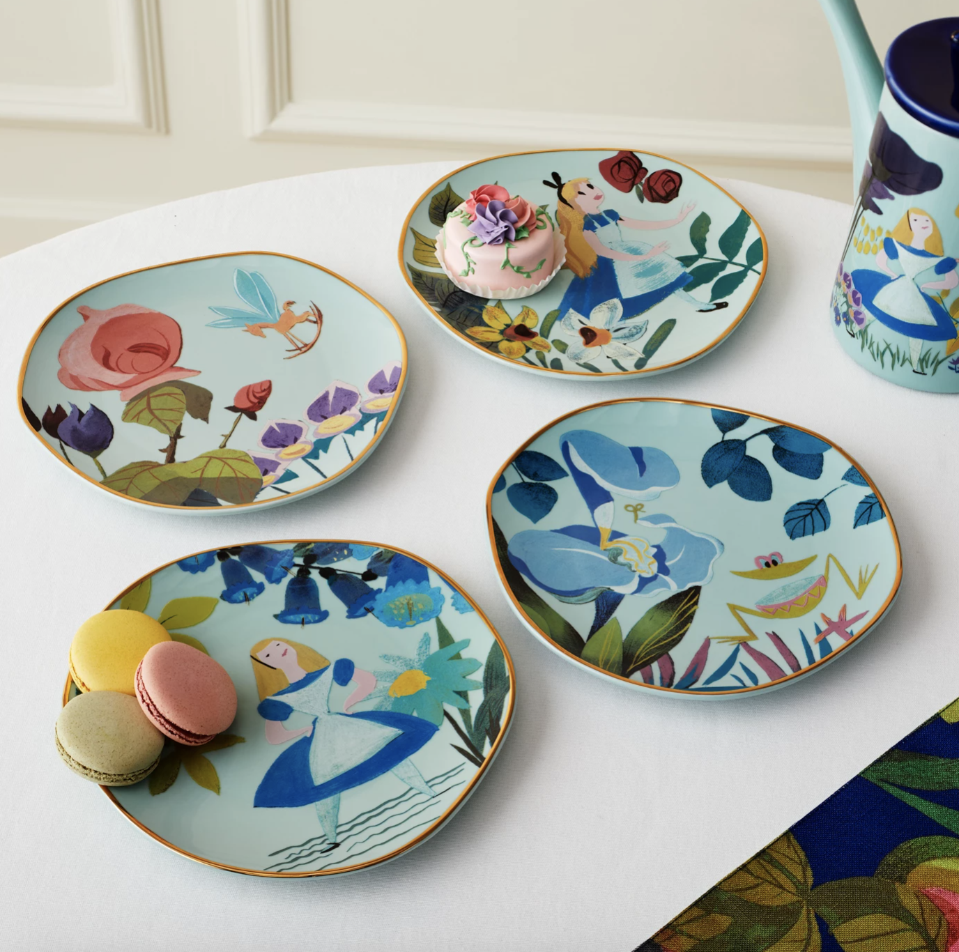 beautiful floral plates with scenes from alice in wonderland on them