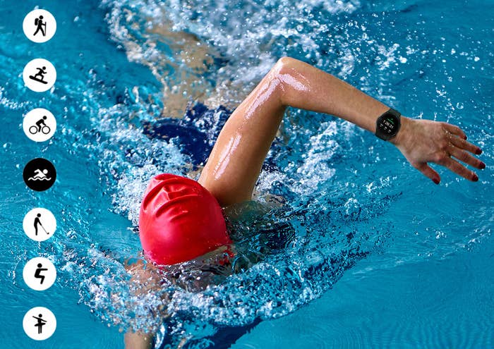 Person wearing red swim cap does laps in pool