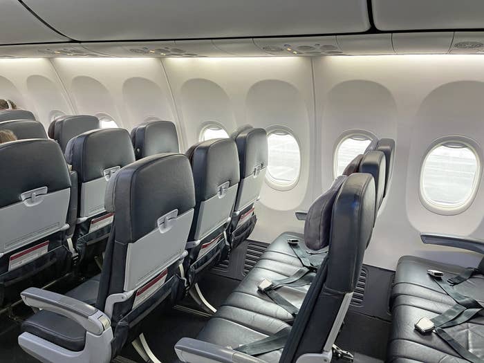 An empty row of airplane seats.