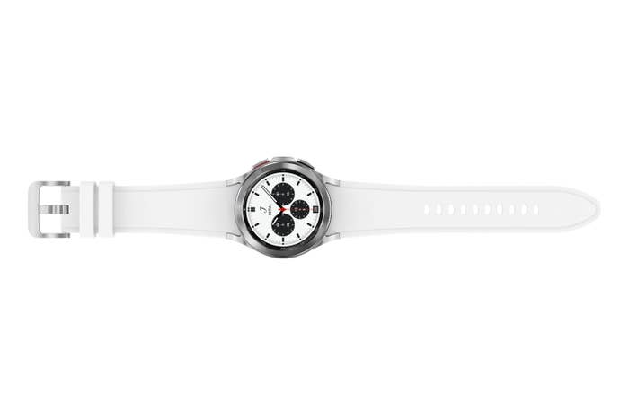 Product image of white Galaxy Watch4 Classic laid out horizontally