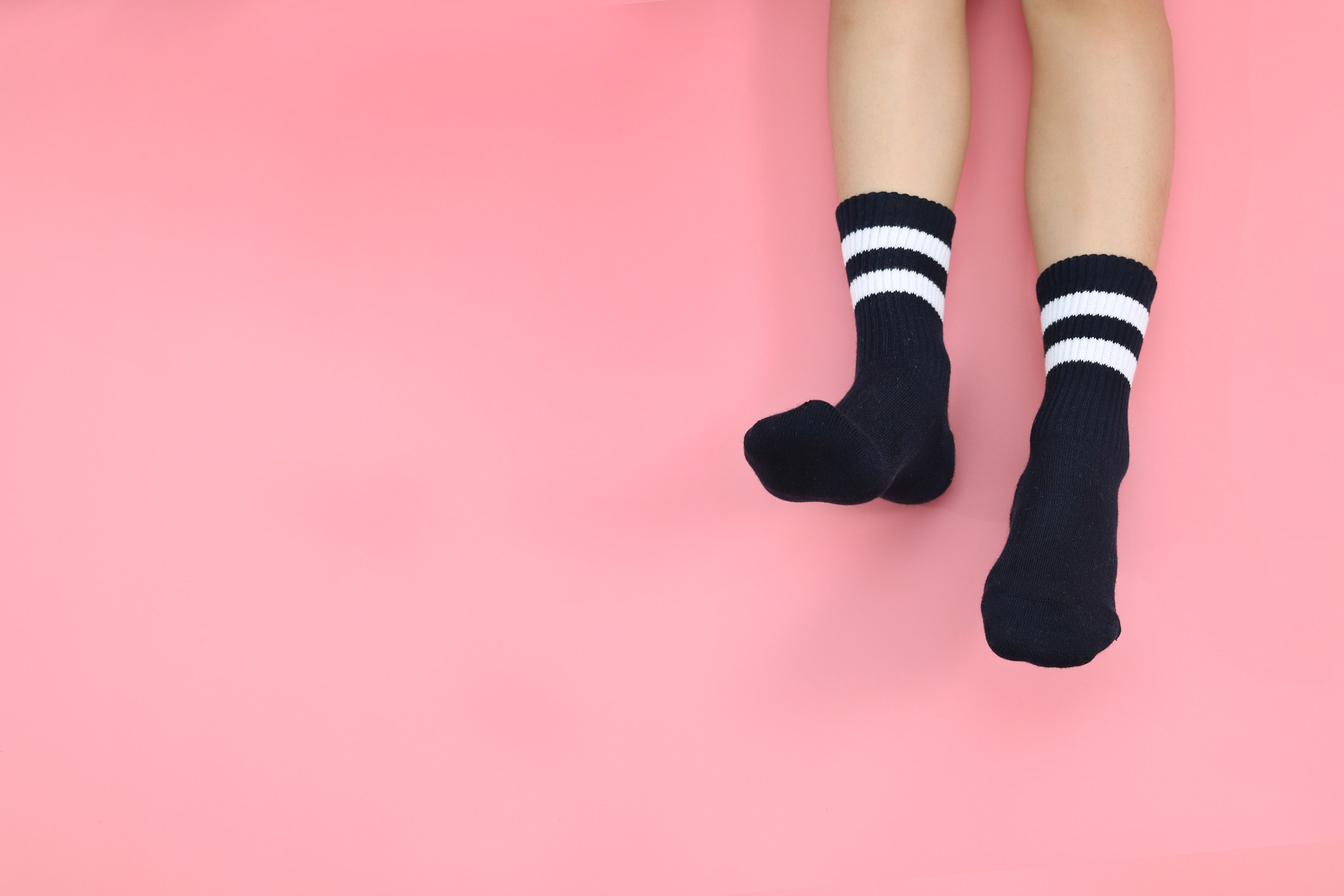 Black and white socks on a person.