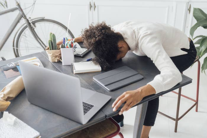 Woman with head on desk