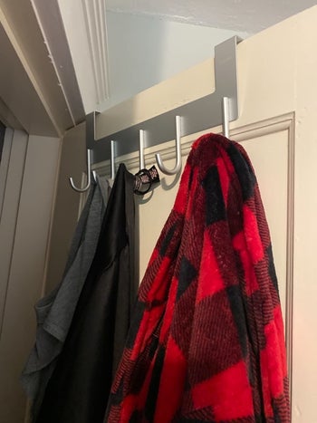 Reviewer's over the door hanger is shown with clothing items hung on it