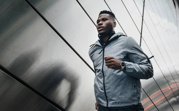 Person runs against industrial backdrop while wearing Galaxy Watch4