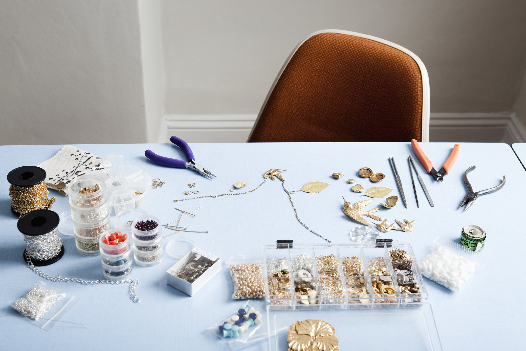 A table filled with materials to make jewelry