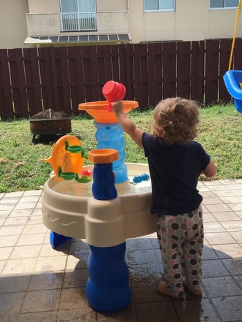 Reviewer's child playing with the water table
