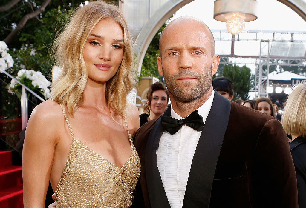 (L to R) Rosie Huntington-Whiteley and actor Jason Statham pose for photos at the 73rd Annual Golden Globe Awards