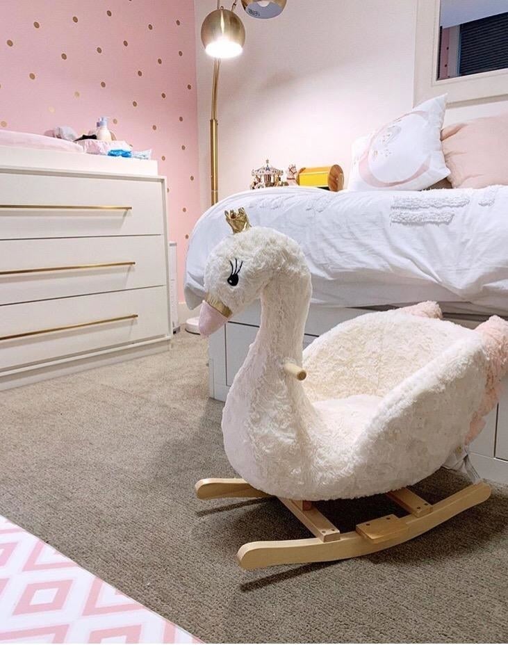 Reviewer's photo showing the swan rocker in a bedroom