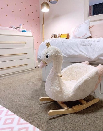 Reviewer's photo showing the swan rocker in a bedroom