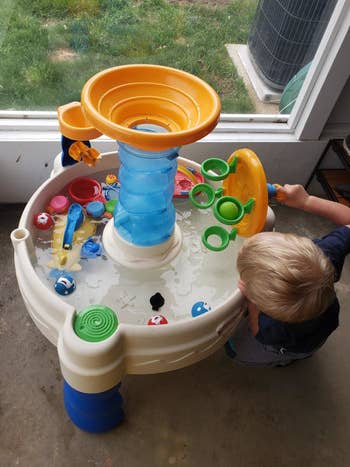 Reviewer's child playing with the water table
