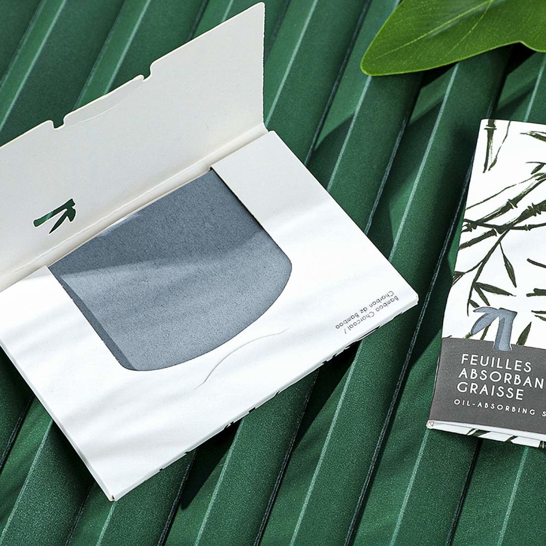 A bamboo charcoal oil-absorbent sheet pack in grey with a white cover