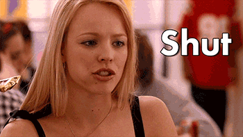 An annoyed regina george says &quot;shut up&quot; while chewing on an energy bar