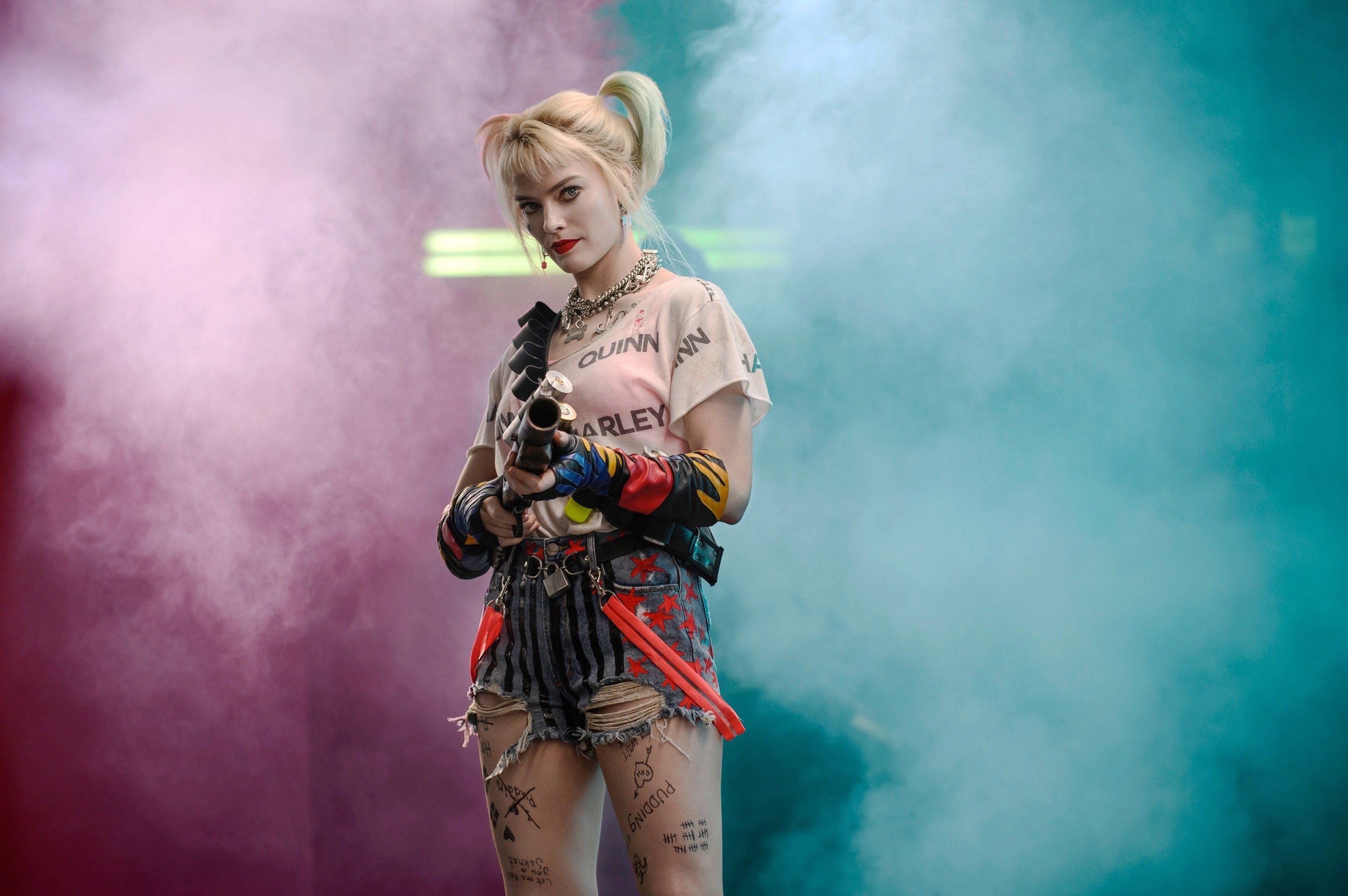 Harley in a t-shirt that says &quot;harley quinn&quot; with american flag jean shorts and suspenders falling down from the belt, as well as the same dog collars and necklaces from the last outfit