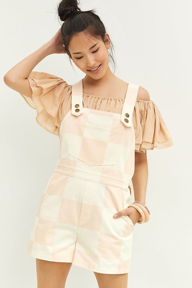 model in cream and pink checked shortalls
