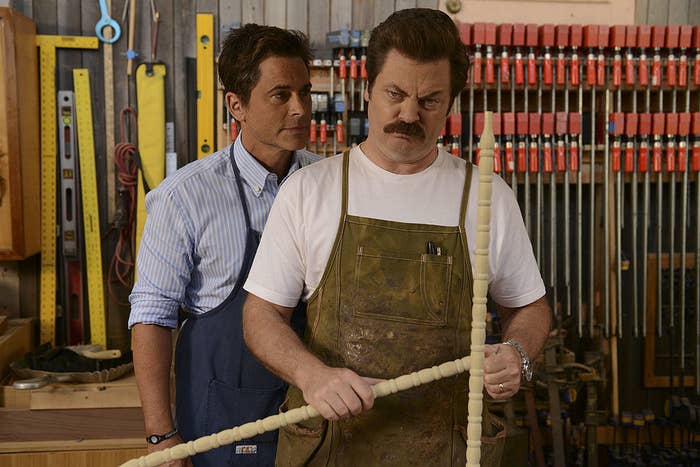 Ron Swanson in his woodworking shop with Chris Traeger looming over him