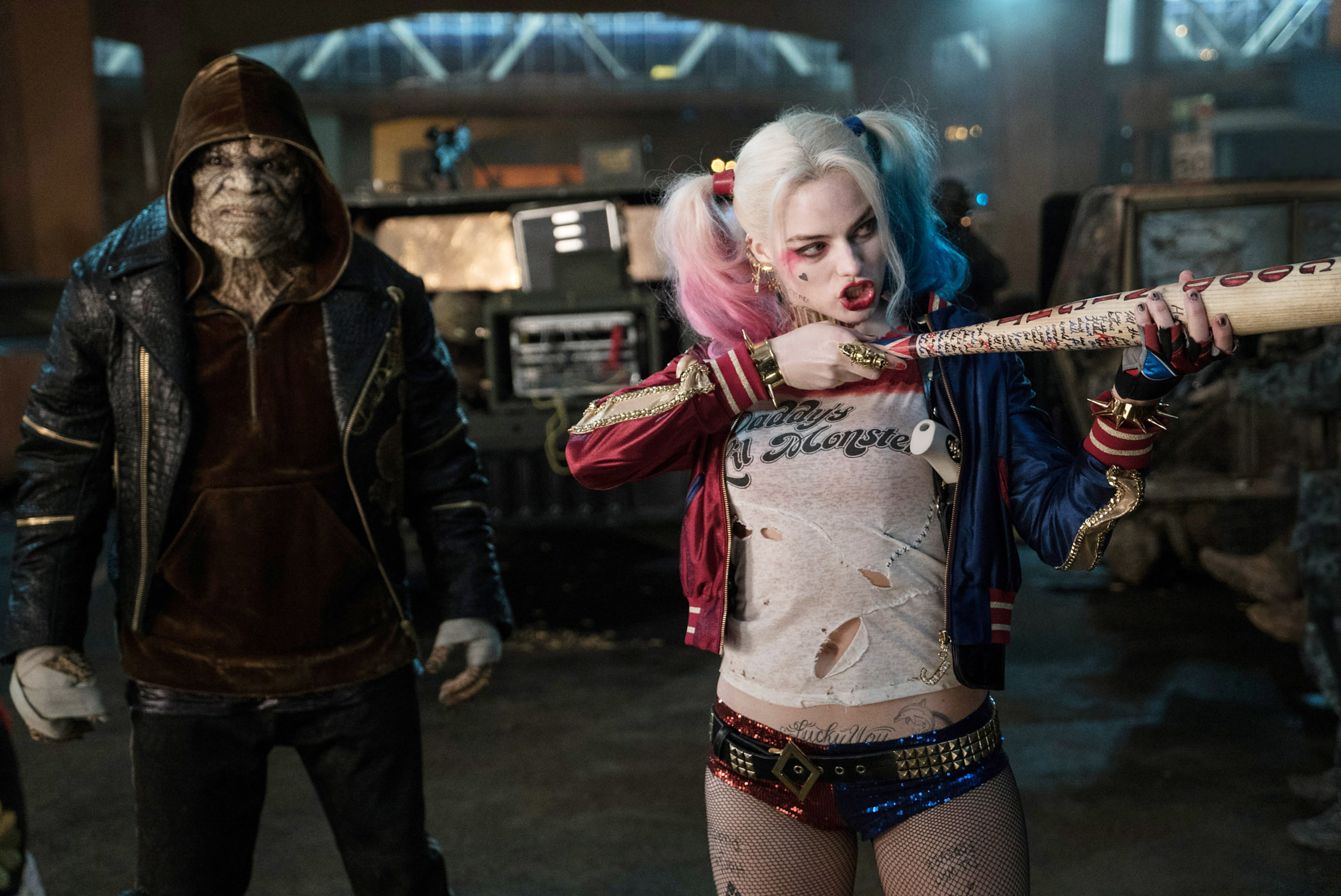 Harley in sequin two-colored underwear with a studded belt, a ripped t-shirt that says &quot;daddy&#x27;s little monster&quot;, and a two-color bomber jacker