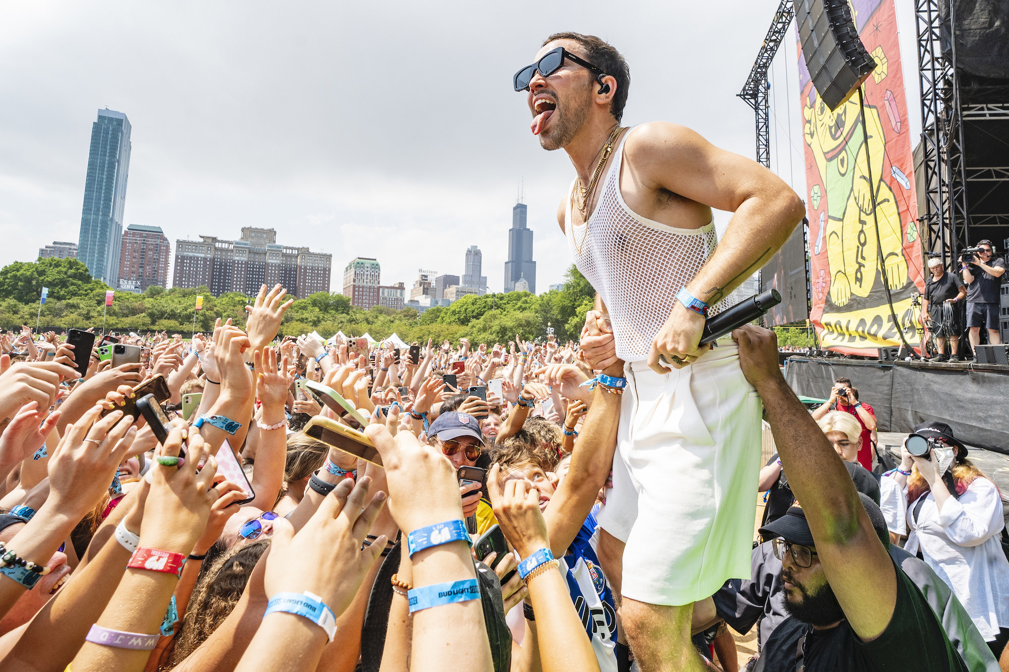 Musician Max Schneider stands above a crowd of young people as he performs at Lollapalooza music festival in Chicago.