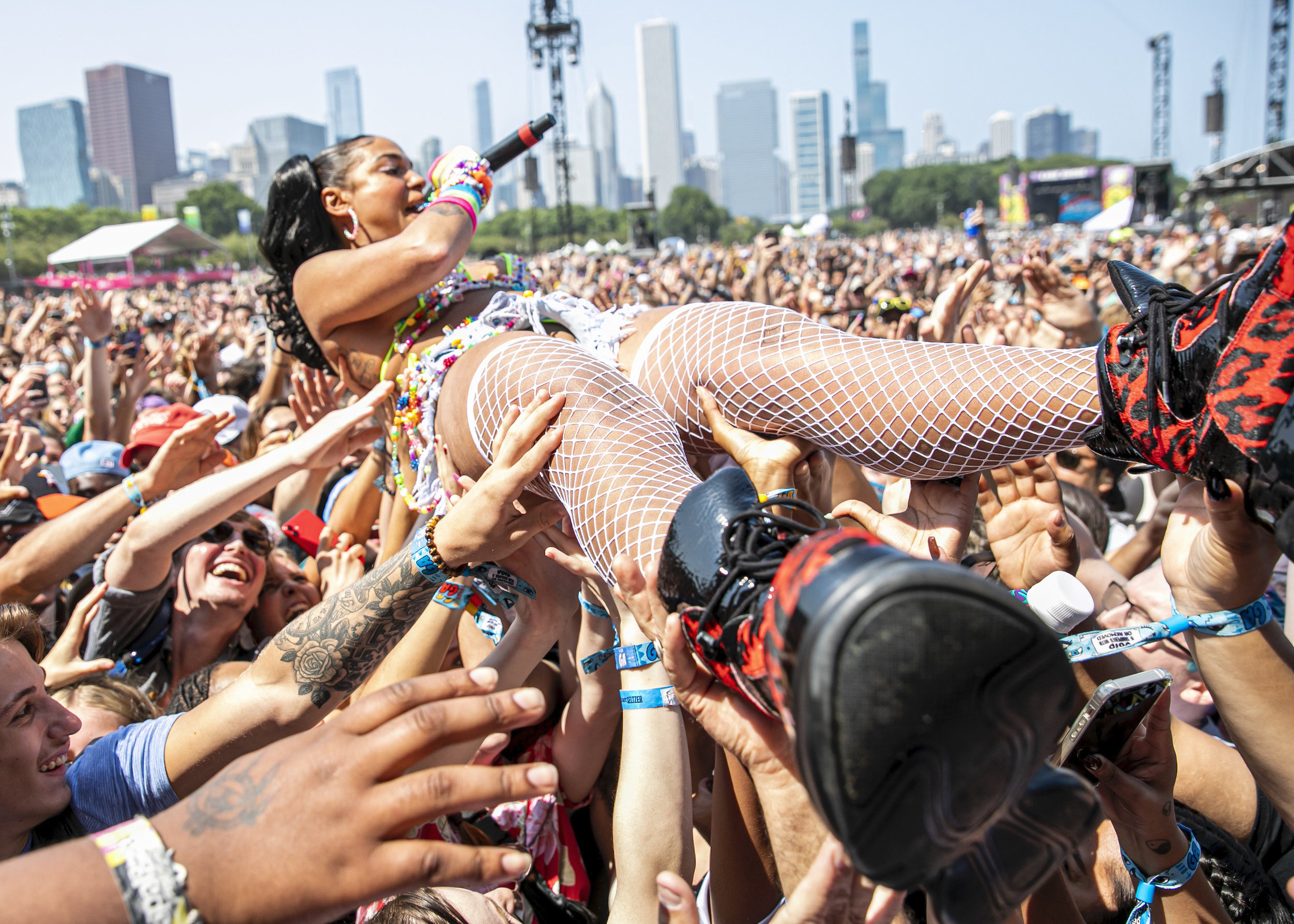 Musician Princess Nokia crowd surfs during her daytime performance at Lollapalooza music festival.