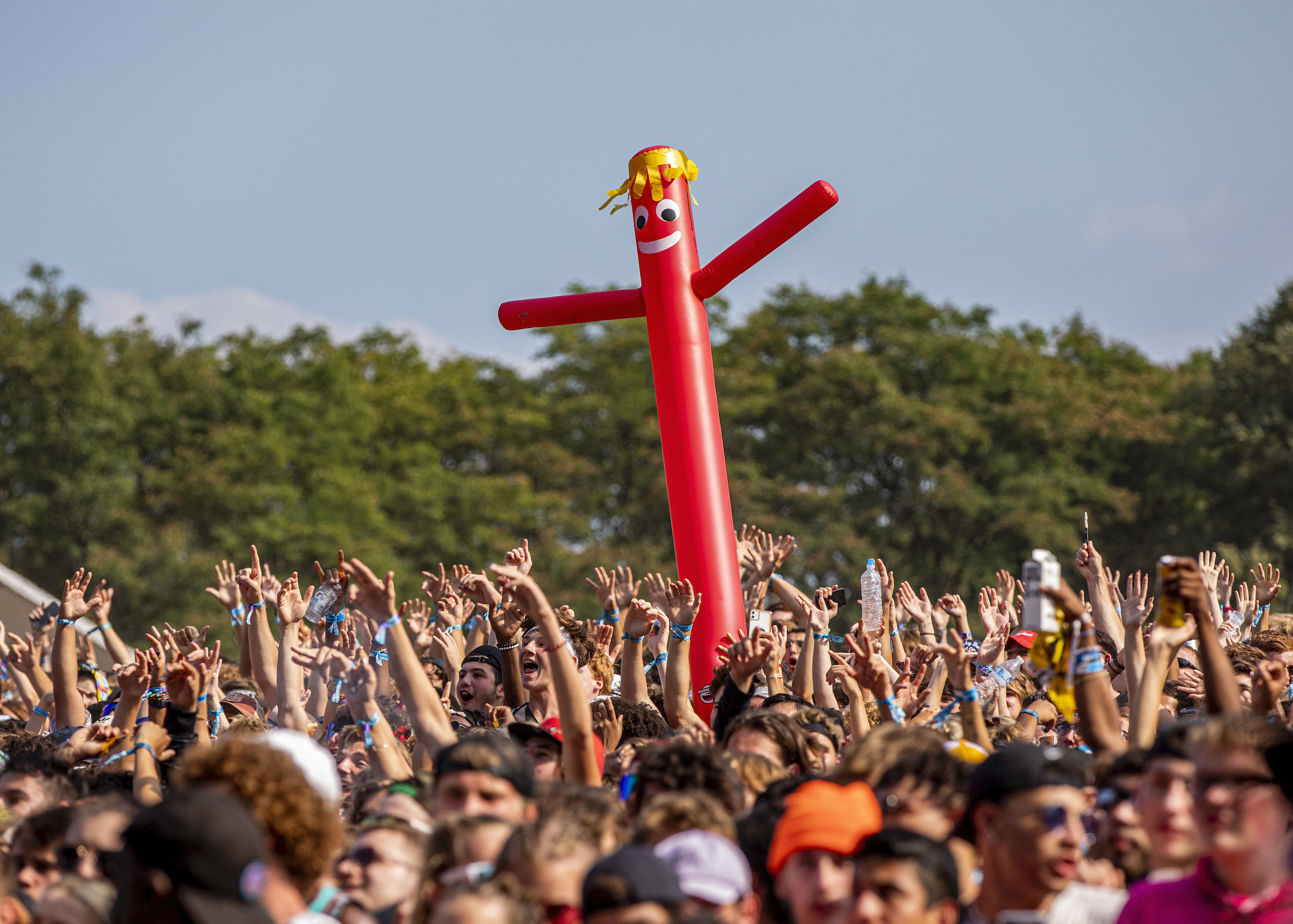 An inflatable character bobs amongst hundreds of hands in the air at Lollapalooza music festival in Chicago.