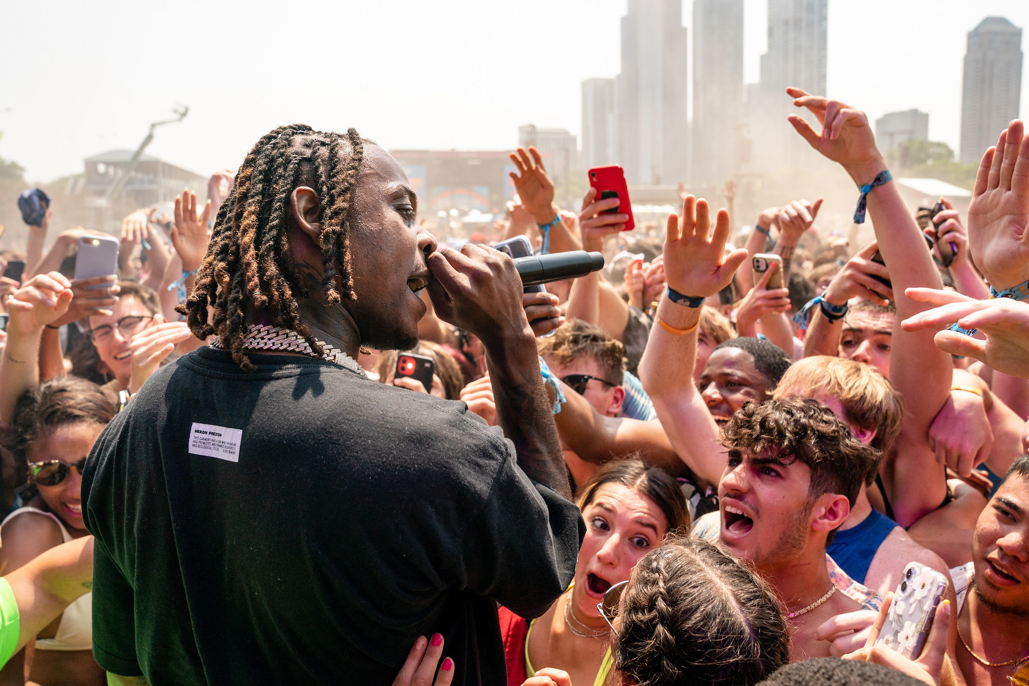 Musician Flipp Dinero sings to an enthusiastic group of young people at Lollapalooza.