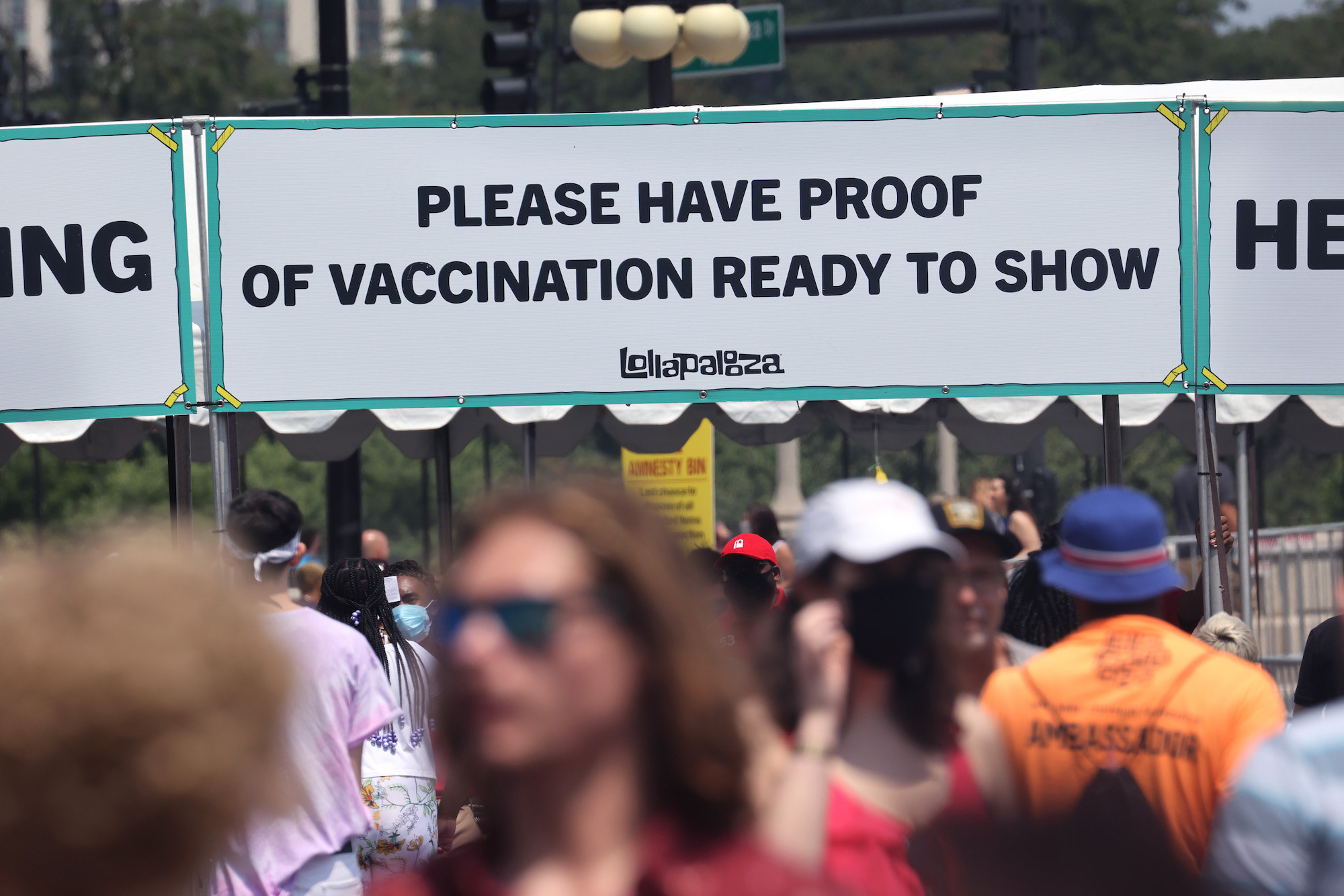 Signage outside of Lollapalooza asks attendees to have proof of vaccination ready to present at gate.