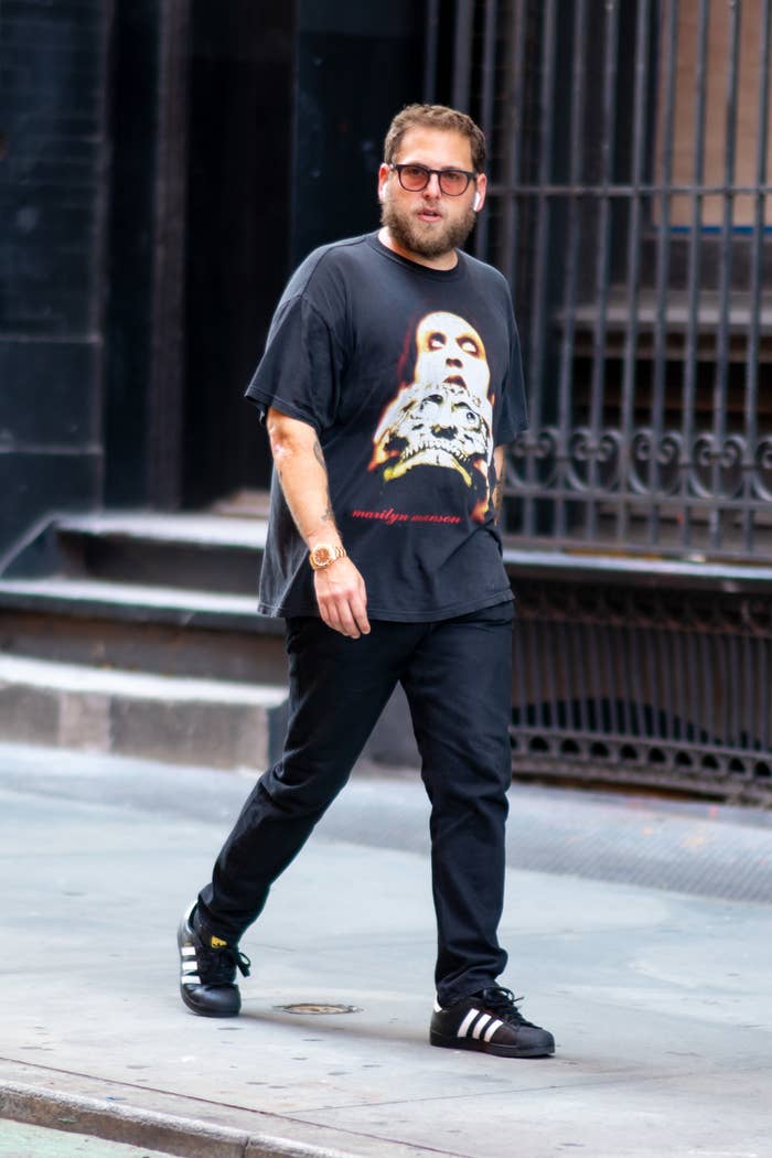 Jonah dressed casually in a tee shirt and jeans as he takes a stroll