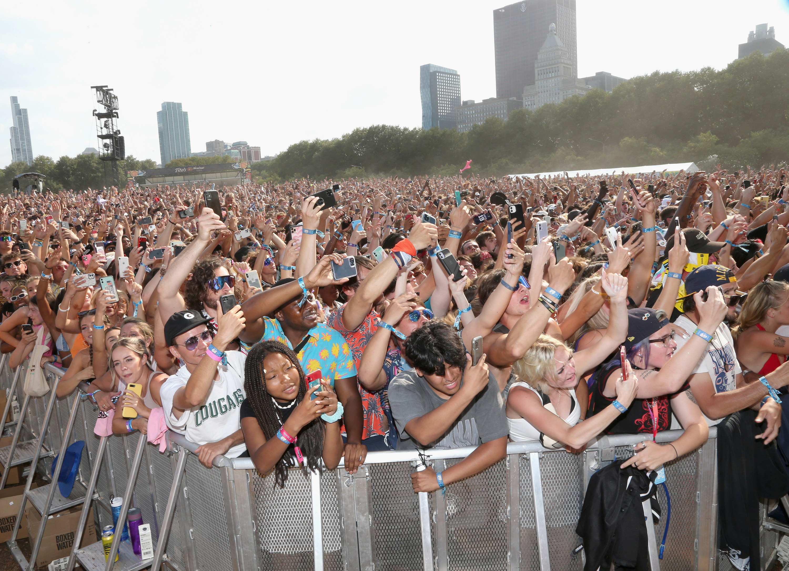 Fans pack behind barricades for the afternoon music set at Lollapalooza music festival.