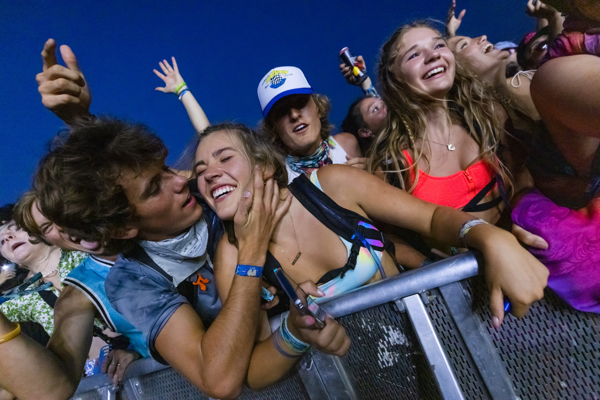 A male attendee motions to kiss a female attendee at Lollapalooza music festival.