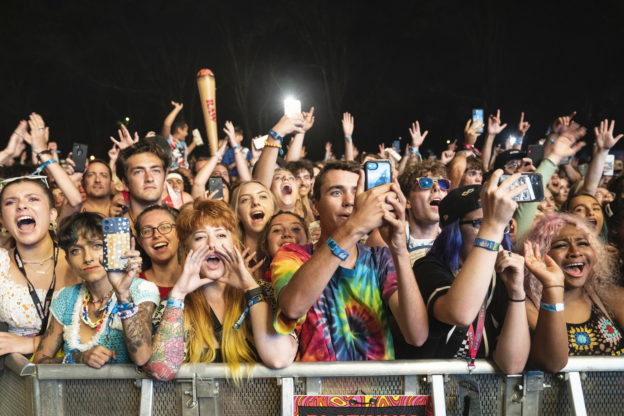 Fans pack behind barricades for the evening music set at Lollapalooza music festival.