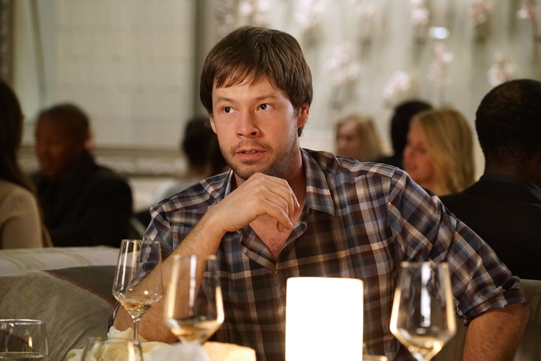 Ike Barinholtz as Morgan Tookers at a restaurant table