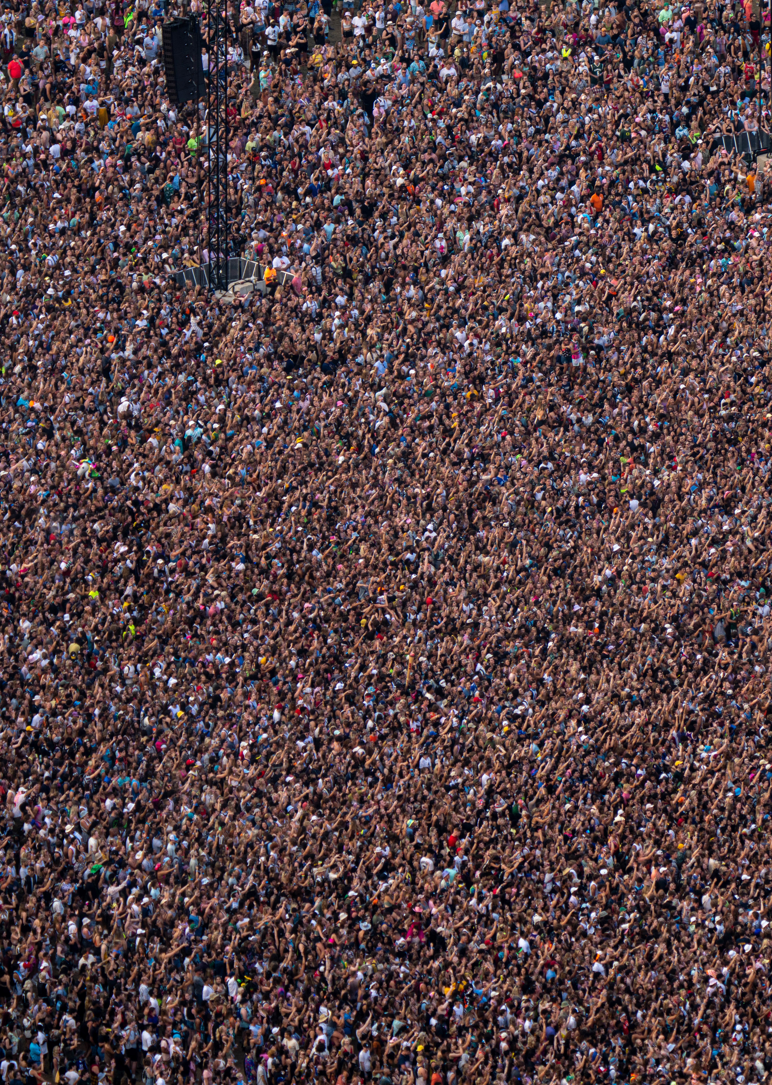 Thousands of people fill the crowd at Lollapalooza music festival in Chicago as seen from above.