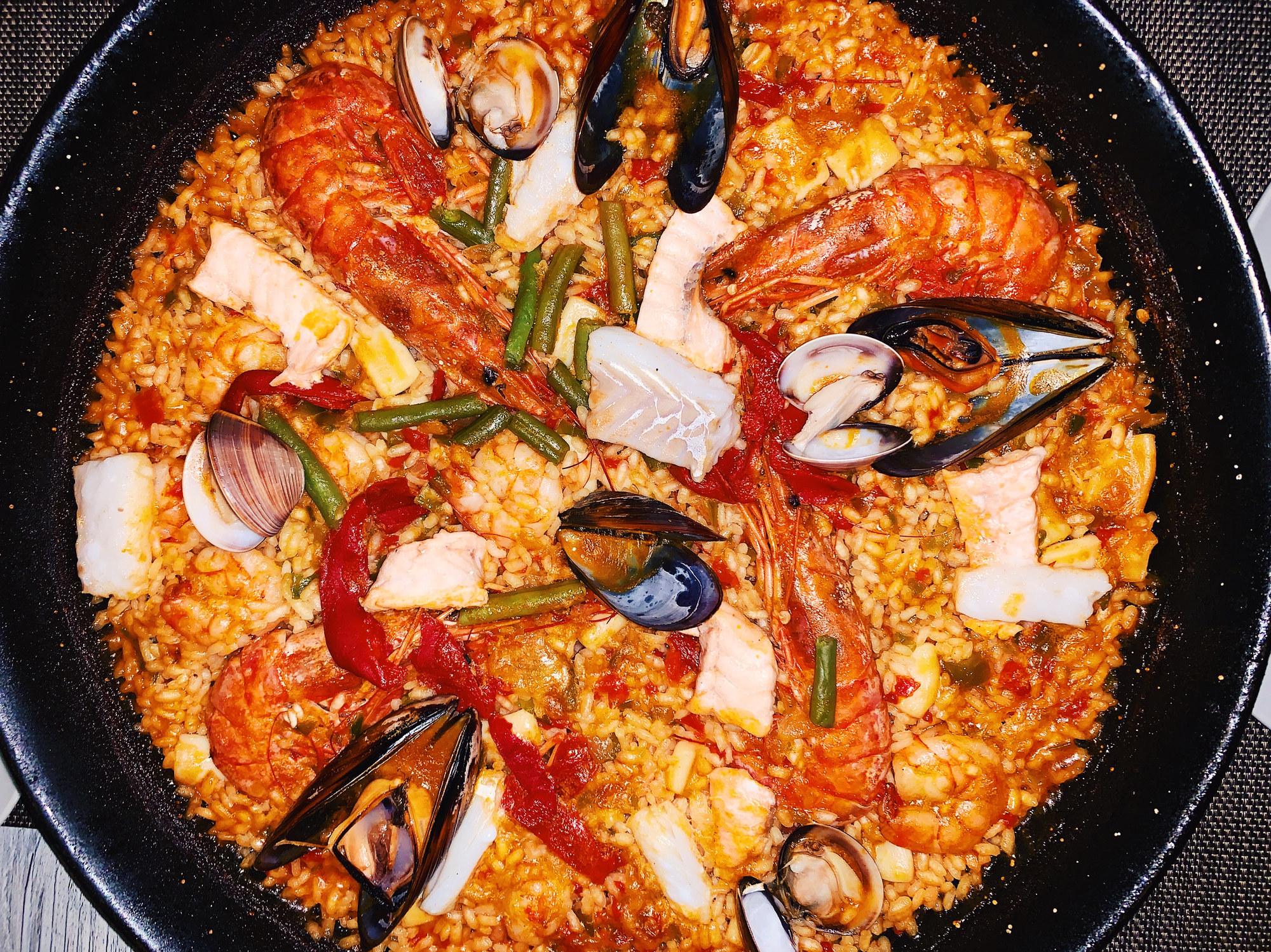 A big pan of paella with seafood.