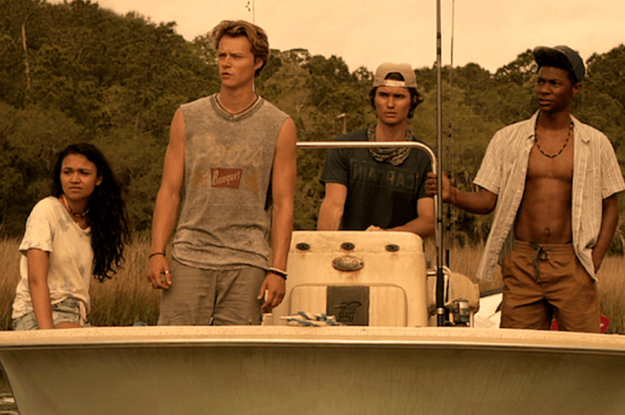 Kiara, JJ, John B, and Pope stand on a small boat as it goes through a swamp