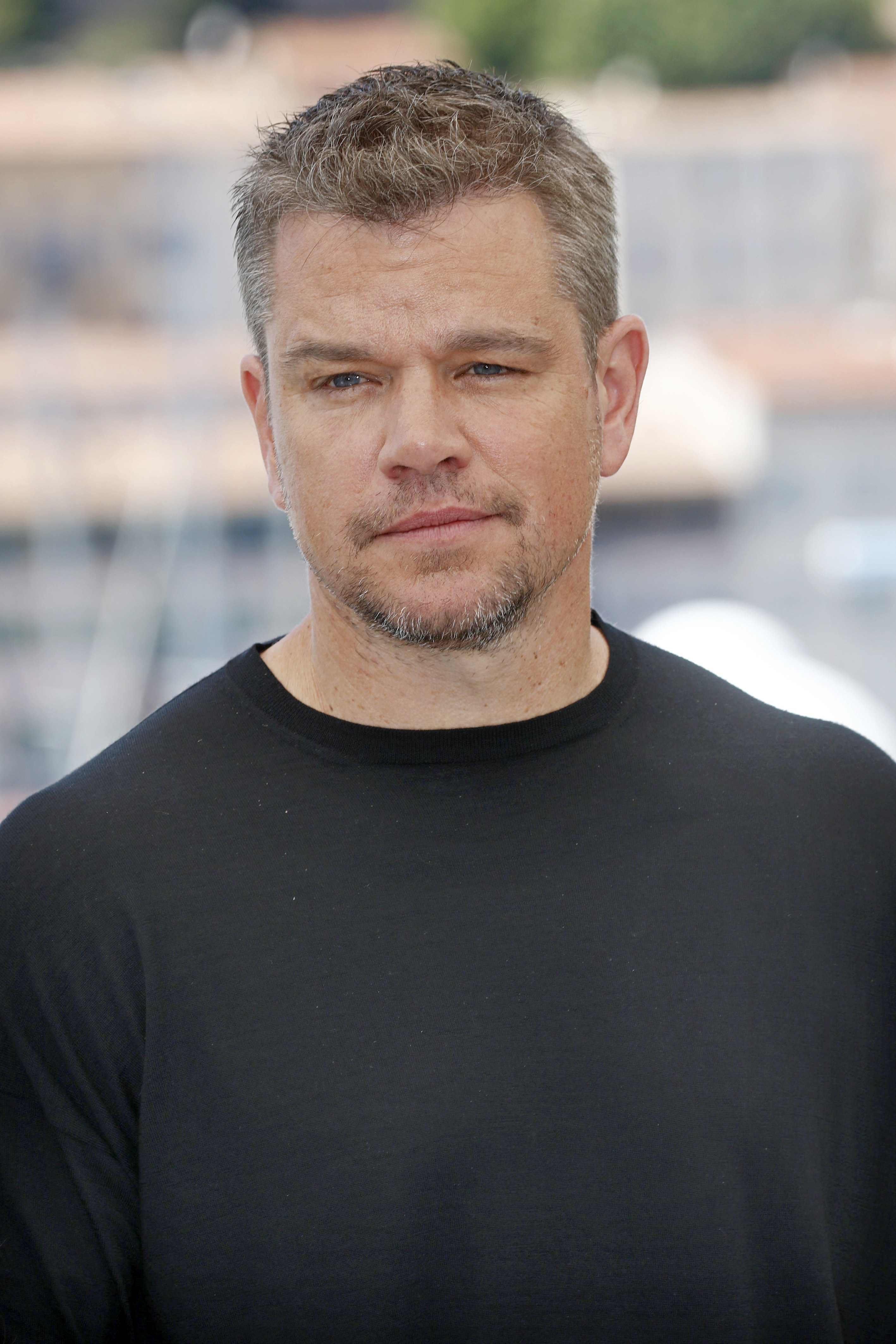 Damon poses for a photo at a film festival while wearing a t-shirt