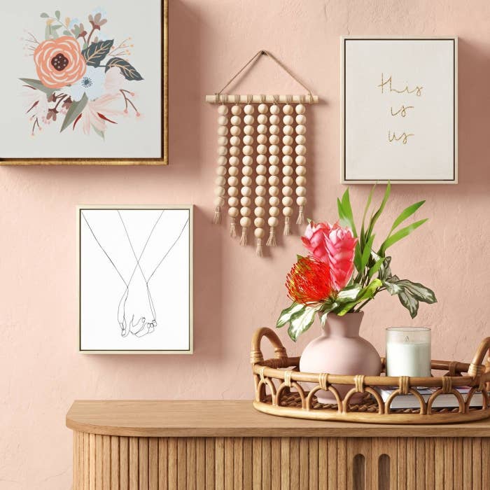 Wooden hanging on pink wall