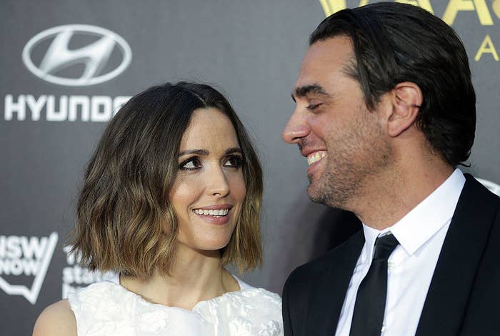 Rose Byrne (L) and Bobby Cannavale smile at each other on the 4th AACTA Awards Ceremony red carpet