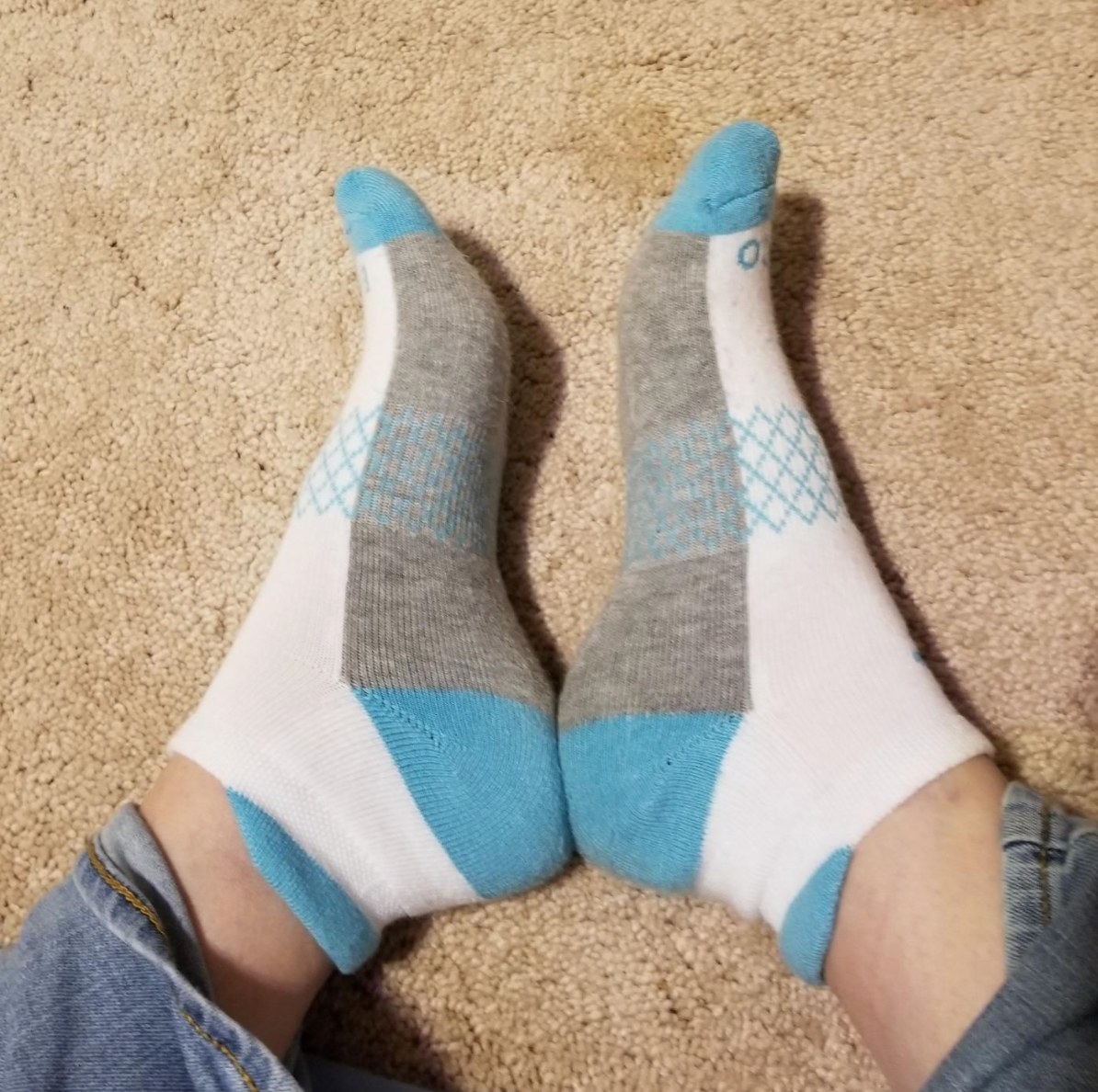 the pair of running socks on a reviewer in white and blue