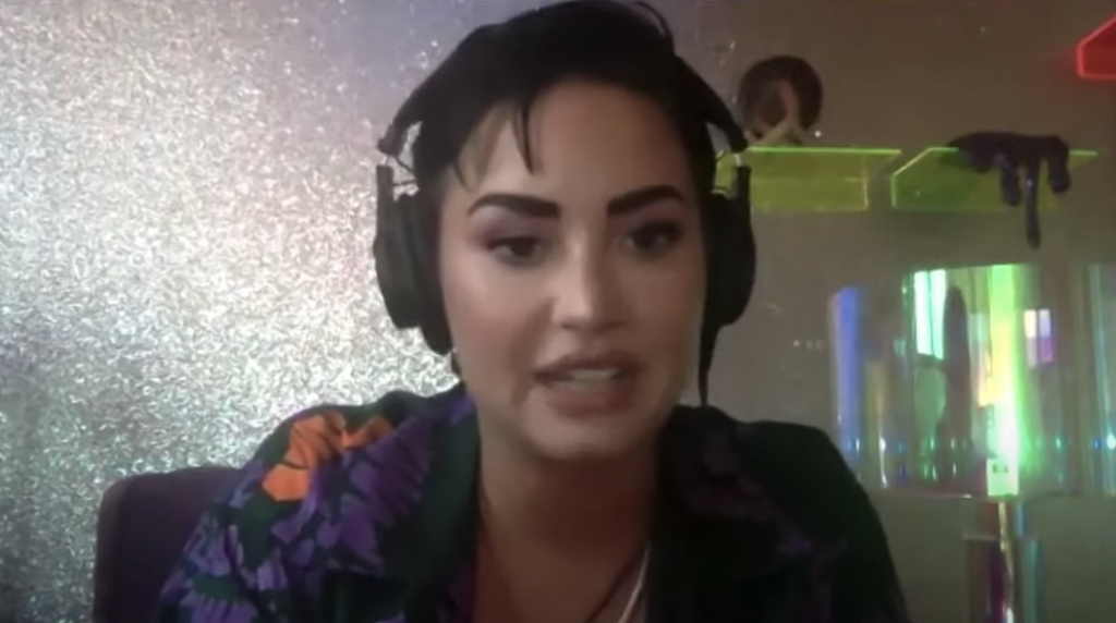 Demi wearing headphones