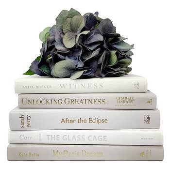a stack of five white books