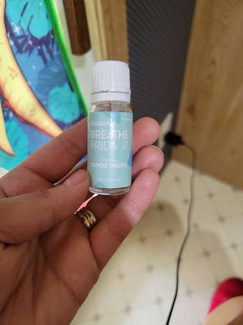 Reviewer holding a bottle of the vapor drops