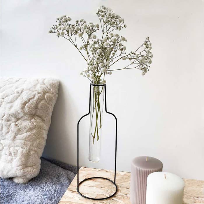 a black outline of a bottle that's actually a vase